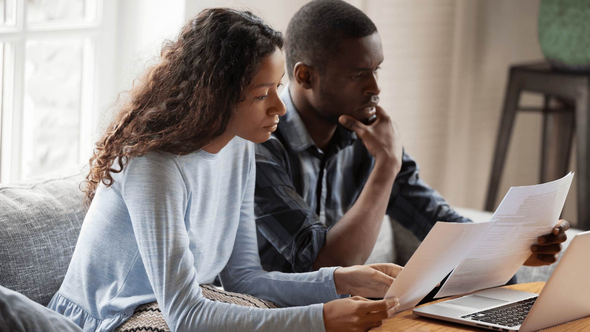 stressed couple doing bills feeling financially uncomfortable