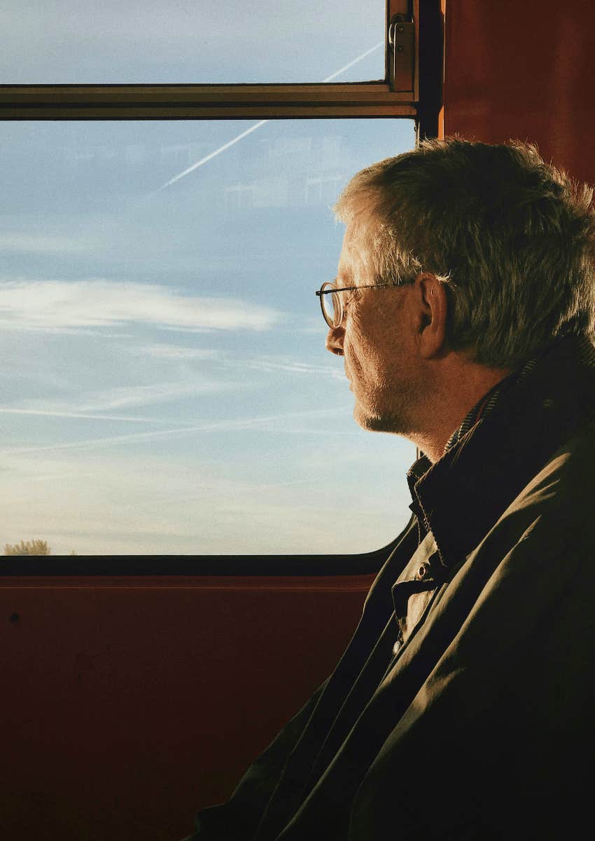thoughtful older man looking out of window