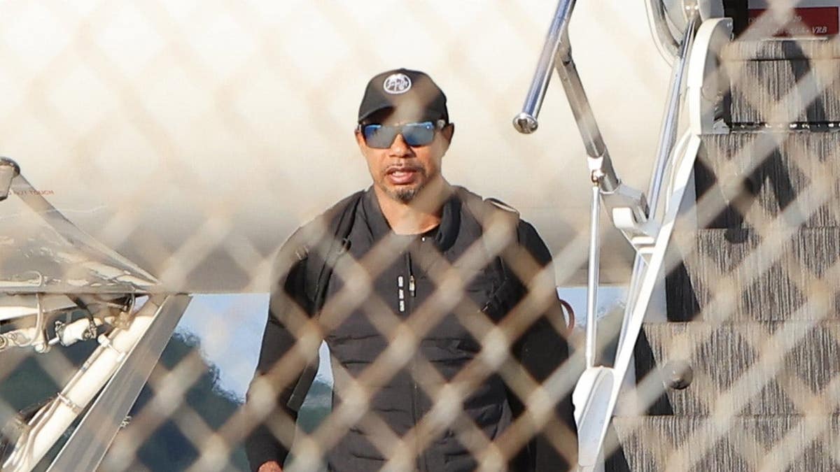 Tiger Woods walking outside after returning home in Palm Beach Florida
