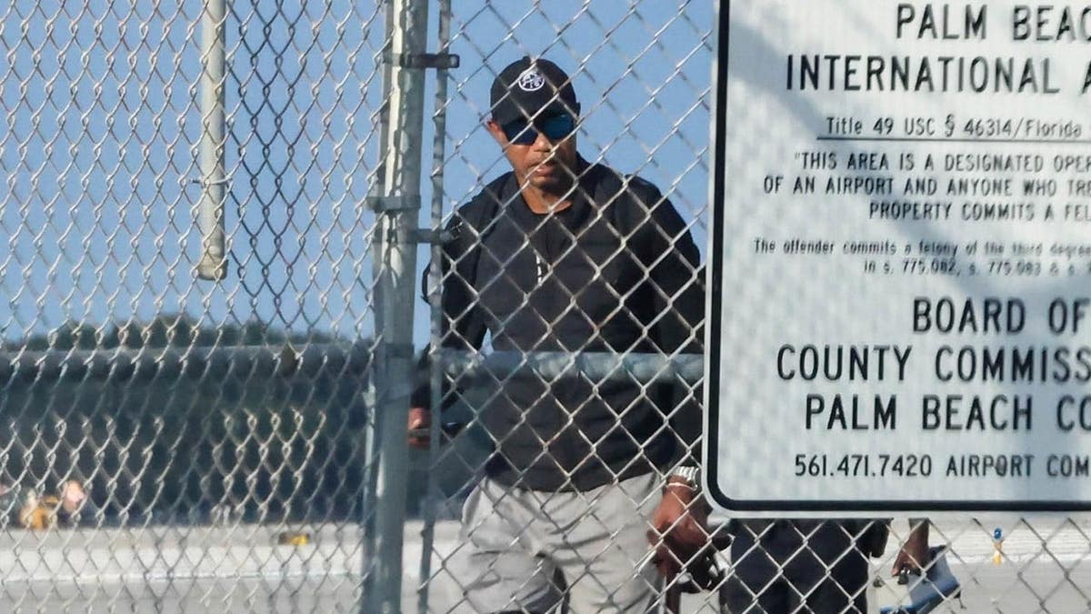 Tiger Woods walking outside after returning home in Palm Beach Florida