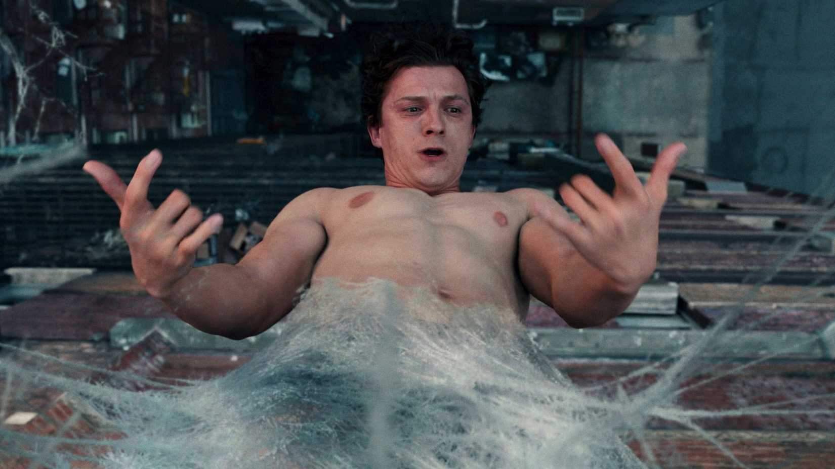 Tom Holland as Peter Parker freaking out while hanging in the air webbed in Spider-Man Brand New Day