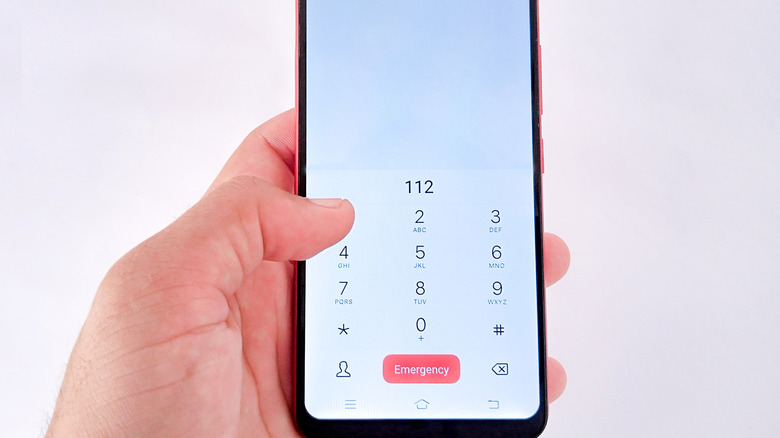 a person typing numbers in the dialer screen on a phone