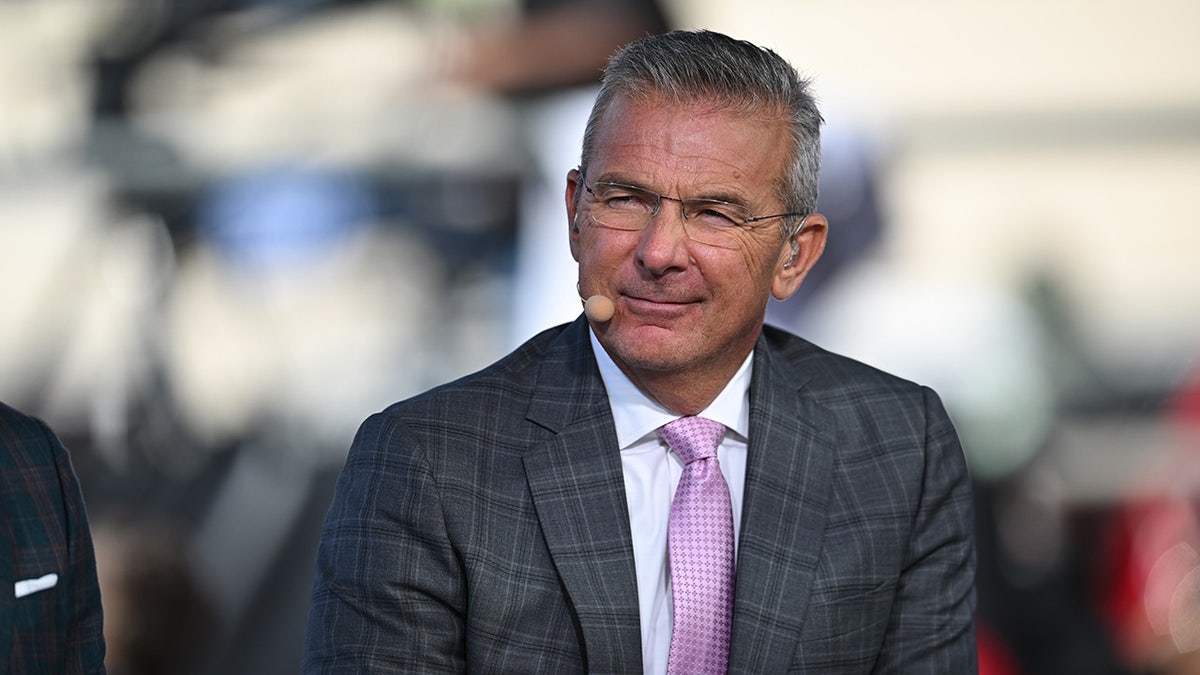 Urban Meyer standing on the sidelines at Memorial Stadium in Bloomington, Indiana.
