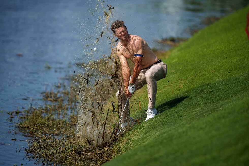 A PGA golfer took his shirt off and approached a gator-filled hazard. AP's photographer was ready