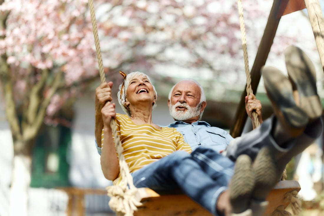 Retired couple on a tree swing.