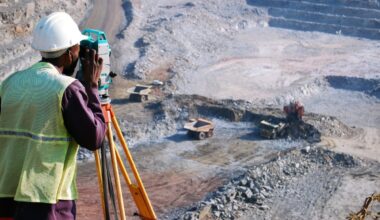 A surveyor looking out over an open mine.