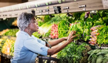 A person in a supermarket produce aisle.