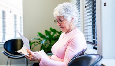A person filling out a form in a waiting room.