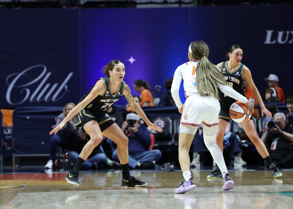 Anneli Maley of the New York Liberty plays defense against the Connecticut Sun.
