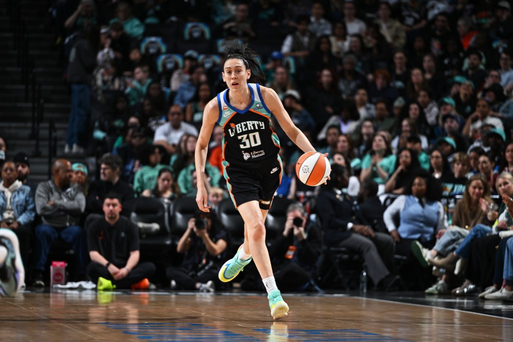 Breanna Stewart of the New York Liberty dribbles the ball during a basketball game.