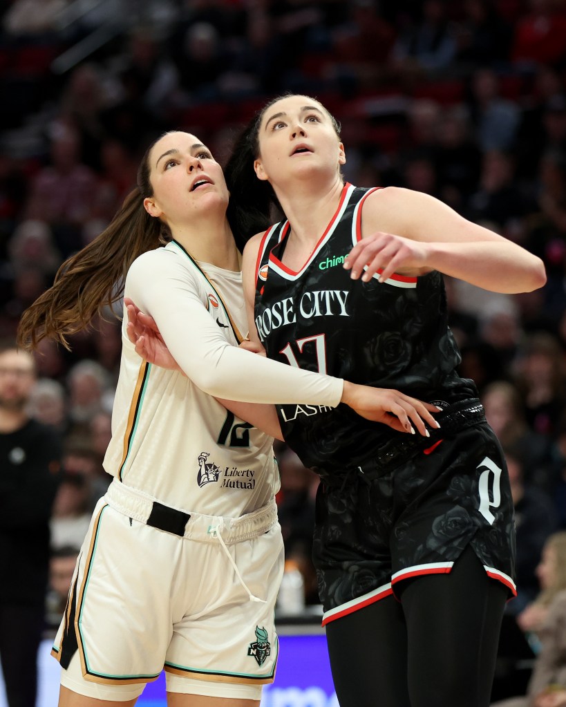 Megan Gustafson #17 of the Portland Fire boxing out Alex Fowler #12 of the New York Liberty.