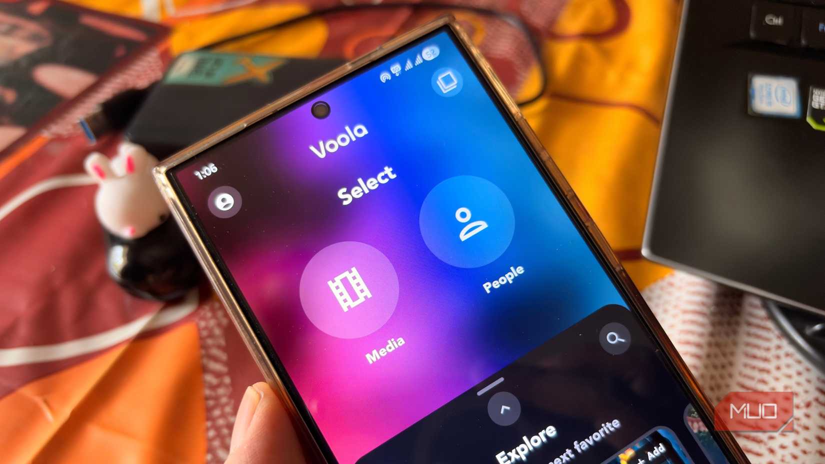 Hand holding a Samsung phone showing Voola app's Media and People selection screen