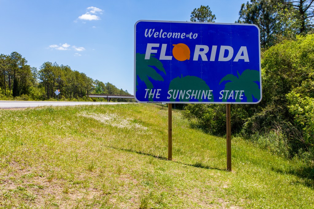 Welcome to Florida sign on the side of a highway.