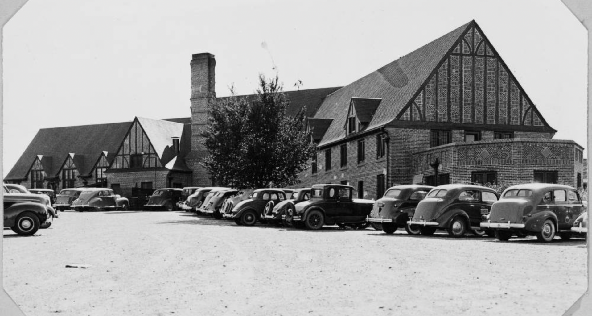 wellshire inn building with old cars