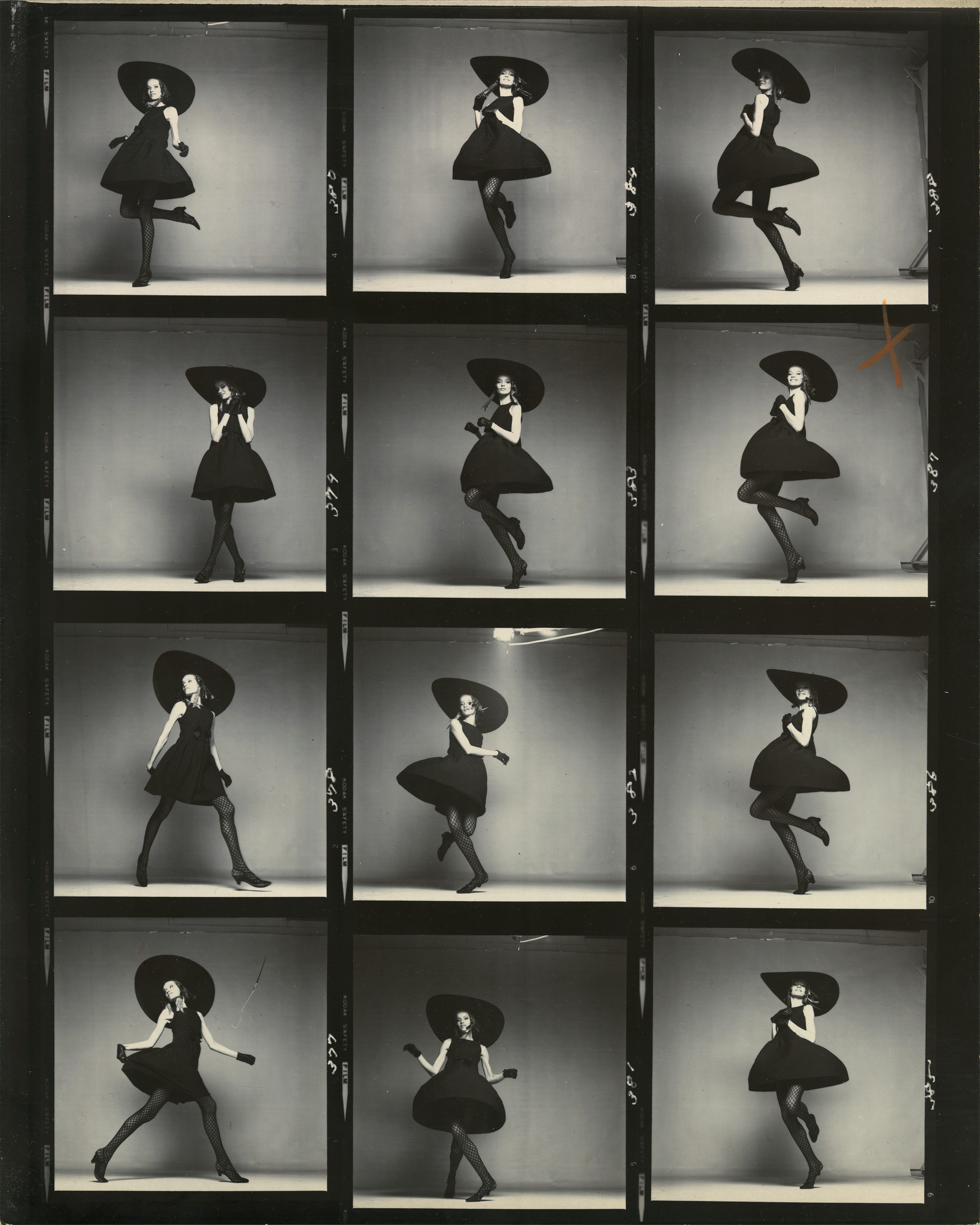 A contact sheet of twelve frames showing a model in a full black skirt and wide-brimmed hat, caught mid-movement across a range of energetic, dancing poses.