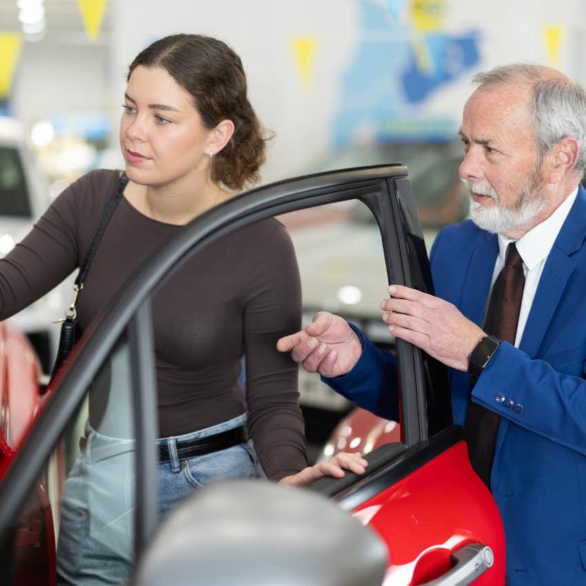 woman with salesman at car dealership
