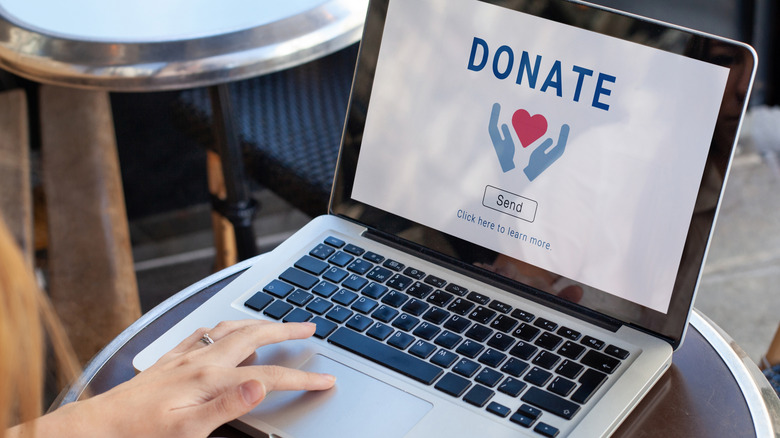 A woman making a donation through an online portal on her laptop.