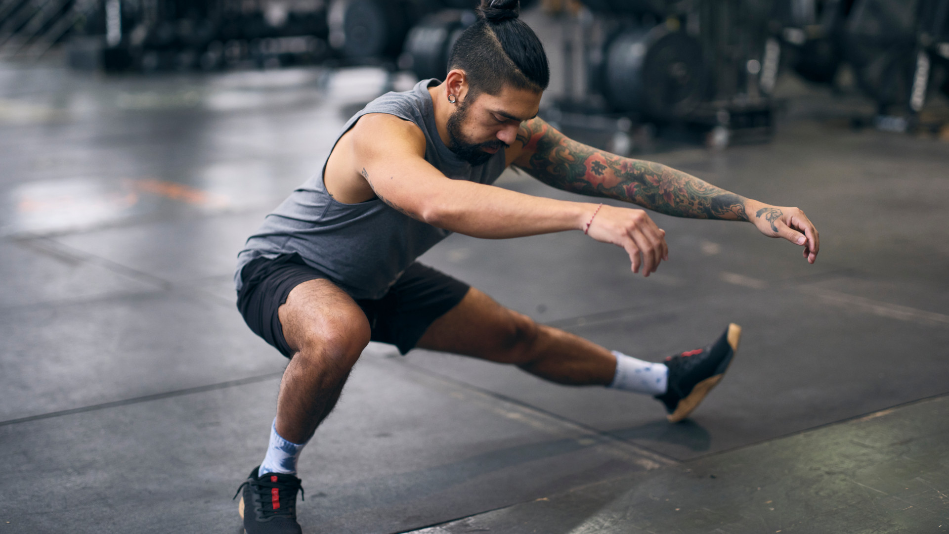 A man performing a cossack squat to improve his hip mobility