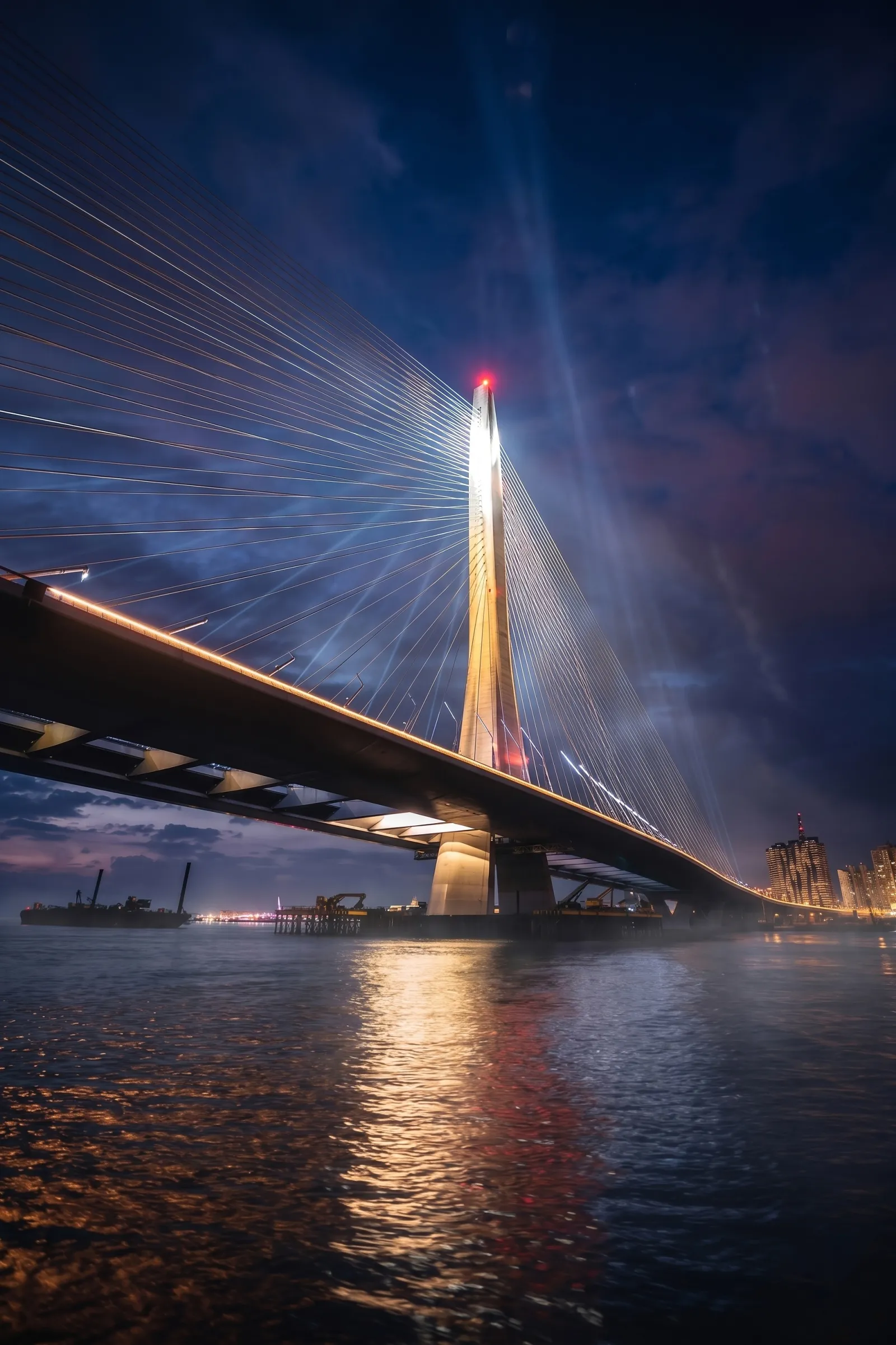A view of the Danjiang Bridge in Taipei by night.