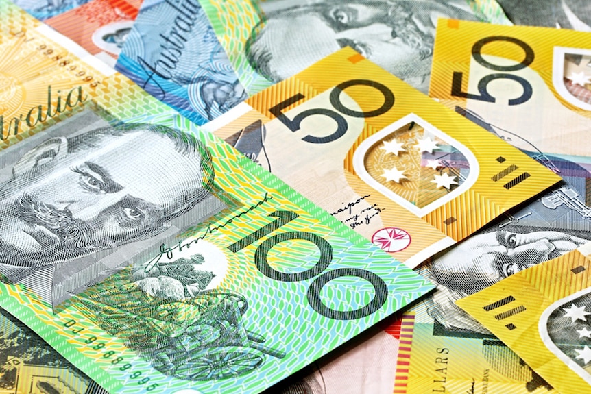 pile of australian currency featuring 100 and 50 dollar notes
