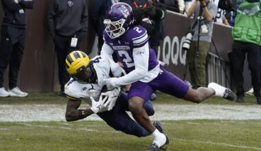 Nov 15, 2025; Chicago, Illinois, USA; Michigan Wolverines wide receiver Andrew Marsh (4) makes a catch as Northwestern Wildcats cornerback Fred Davis II (2) defends him during the first half at Wrigley Field. Mandatory Credit: David Banks-Imagn Images