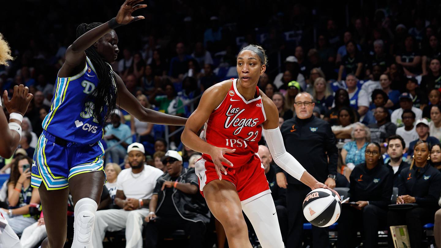 Jun 15, 2026; Arlington, Texas, USA; Las Vegas Aces center A'ja Wilson (22) controls the ball as Dallas Wings forward Awak Kuier (34) defends during the first half at College Park Center. Mandatory Credit: Chris Jones-Imagn Images