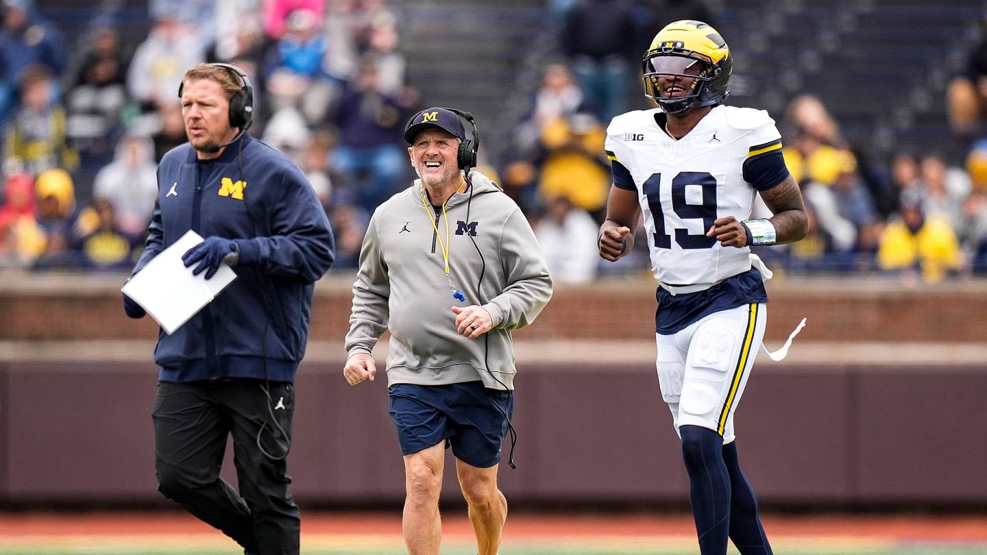 Michigan offensive coordinator Jason Beck, left, head coach Kyle Whittingham, center, and quarterback Bryce Underwood run across the field during the spring game at Michigan Stadium in Ann Arbor on Saturday, April 18, 2026.
