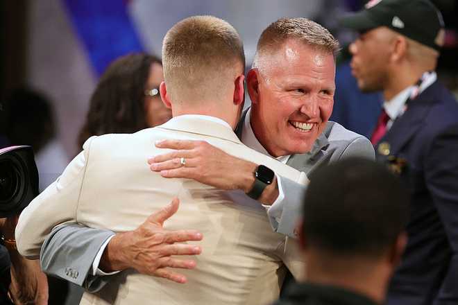 2026 NBA Draft - Round One NEW YORK, NEW YORK - JUNE 23: Bennett Stirtz is congratulated by his father Roger Stirtz after he is drafted sixteenth overall by the Memphis Grizzlies during Round One of the 2026 NBA Draft at Barclays Center on June 23, 2026 in New York City. (Photo by Arturo Holmes/Getty Images)