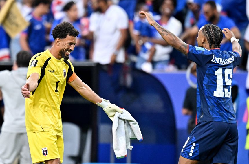 Cape Verde's Vozinha celebrates with Dailon Livramento after the match as they qualify for the knockout stages of the World Cup.