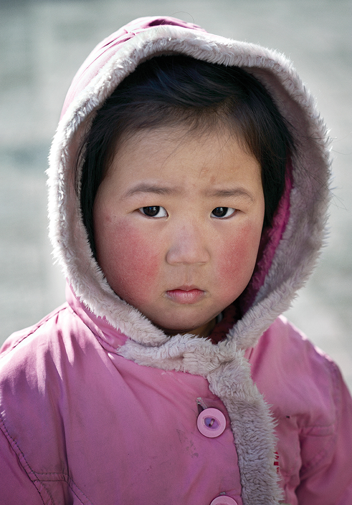 PYONGYANG, NORTH KOREA - FEBRUARY 2008: A young girl in the North Korean capital of Pyongyang during the visit of the New York Philharmonic. Pyongyang, North Korea.