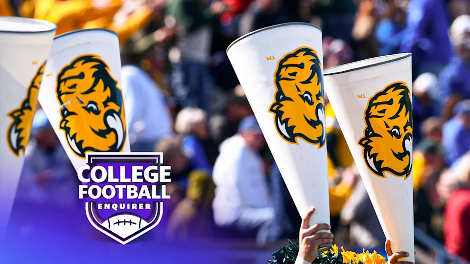 North Dakota State University Bison cheerleaders hold megaphones in the air during the game with the Indiana State University Sycamores