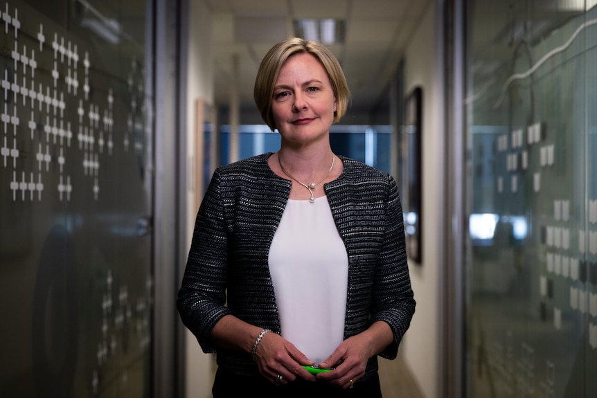 A mid-shot of WA auditor-general Caroline Spencer posing for a photo with her hands clasped.
