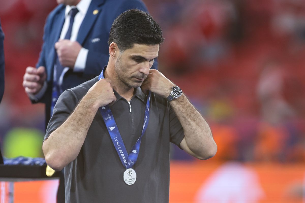 A dejected Mikel Arteta manager / head coach of Arsenal picks up his runners up medal during the UEFA Champions League Final 2026 match between Paris Saint-Germain and Arsenal FC at Puskas Arena on May 30, 2026 in Budapest, Hungary