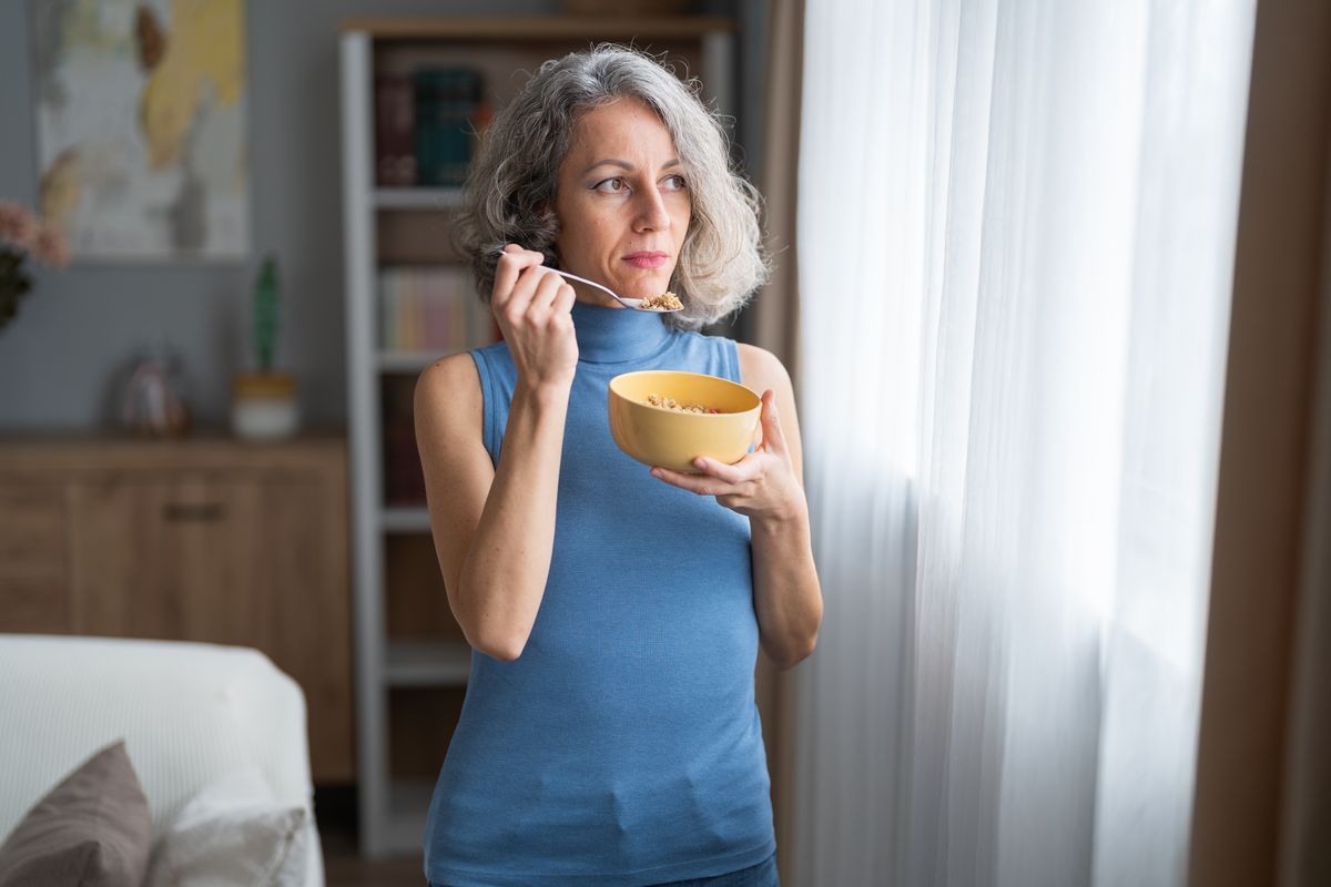 A woman eats breakfast