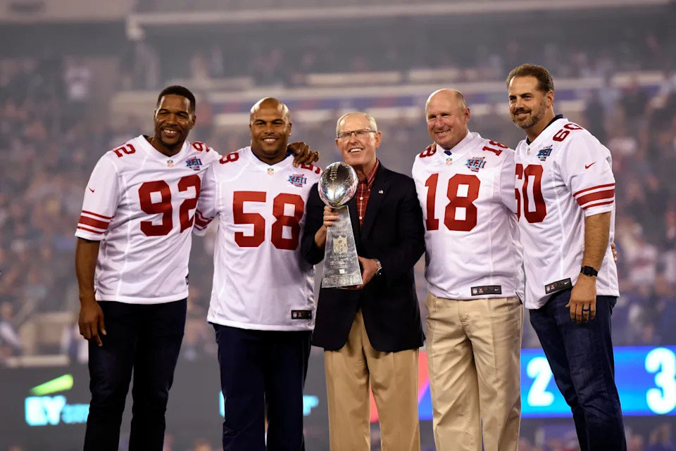 (L-R) From the 2007 Super Bowl XLII winning team, Michael Strahan, Antonio Pierce, head coach Tom Coughlin, Jeff Feagles, and Shaun O'Hara stand on the stage during the ceremony. New York Giants against the Detroit Lions in their home opener on Monday, September 18, 2017 in East Rutherford.