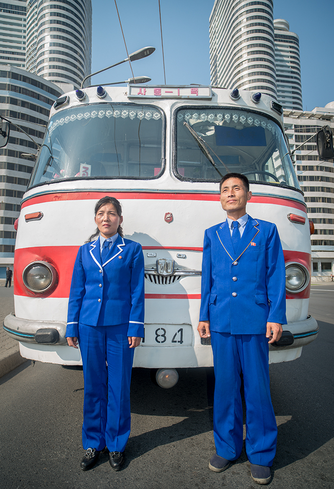 Conductor and driver for a historic bus in Pyongyang, North Korea.