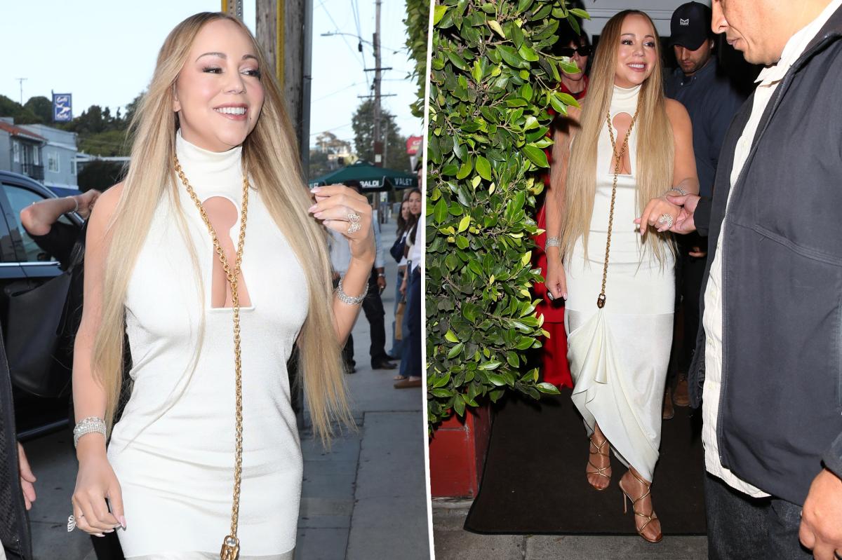 Mariah Carey keeps her Schiaparelli dress off the ground with a necklace
