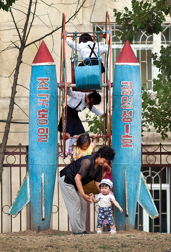 SONBONG, NORTH KOREA - JULY 2011: Children playing in a schoolyard in Sonbong, North Korea.