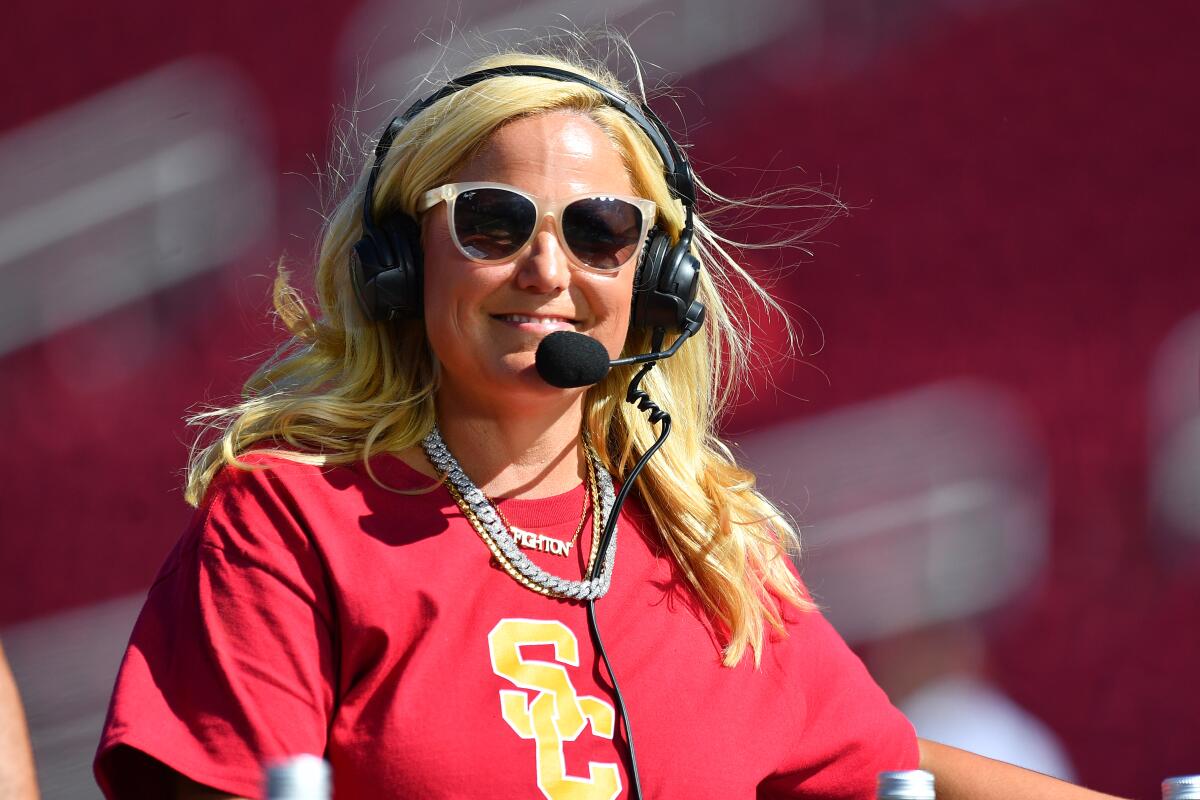 USC athletic direct Jennifer Cohen wears a headset with microphone as she's interviewed before a football game in 2023.