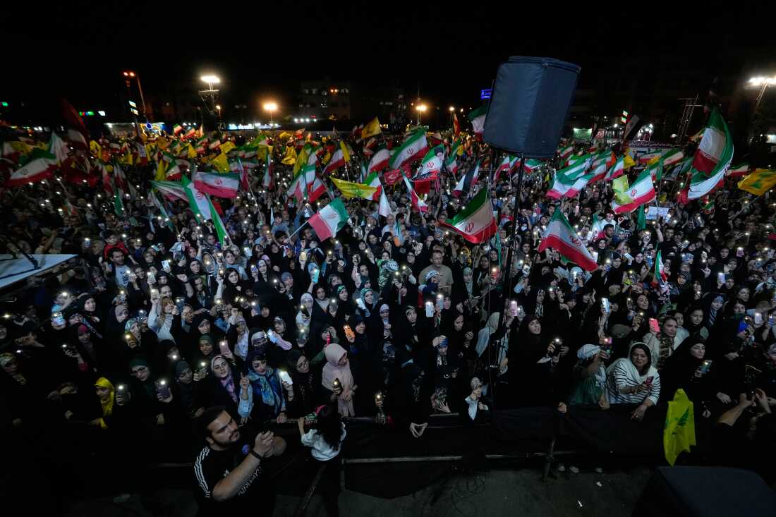 Demonstrators wave Iranian flags and flags of Lebanon's militant Hezbollah group during a pro-government gathering at Islamic Revolution Square in Tehran, Iran, Saturday, May 30, 2026.