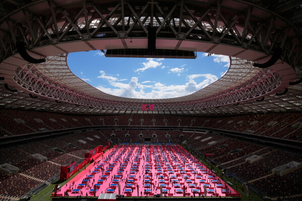 People play table tennis on the pitch of the Luzhniki Stadium during the table tennis festival in Moscow, Sunday, May 31, 2026. (AP Photo/Pavel Bednyakov)