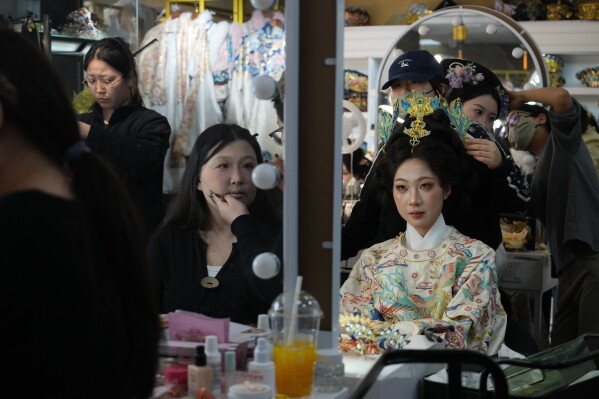 Women get made up with historical Chinese costumes at studio near the Forbidden City in Beijing on Saturday, April 4, 2026. (AP Photo/Ng Han Guan)