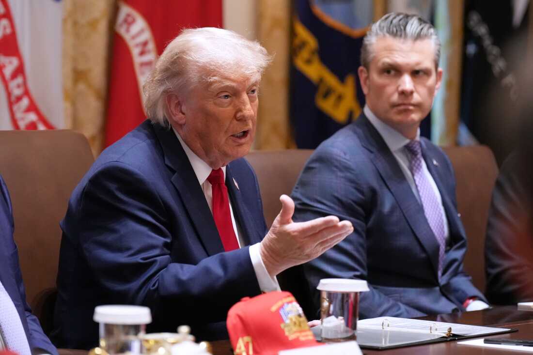 President Donald Trump speaks during a Cabinet meeting at the White House, Wednesday, May 27, 2026, in Washington, as Secretary of Defense Pete Hegseth, looks on.