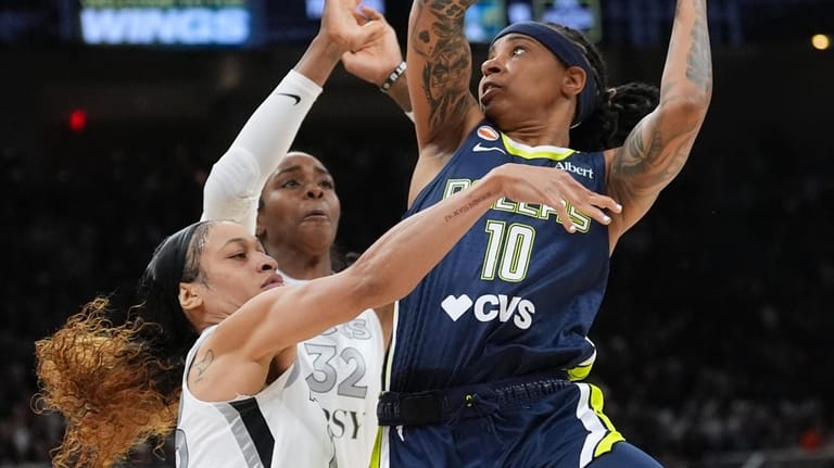 Dallas Wings guard Aziaha James (10) drives to the basket...