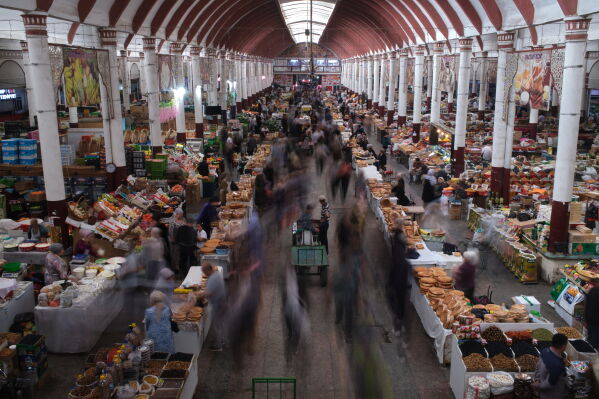 People traverse Panjshanbe Bazaar in Khujand, Tajikistan, Sunday, May 3, 2026. (AP Photo/Jon Orbach)