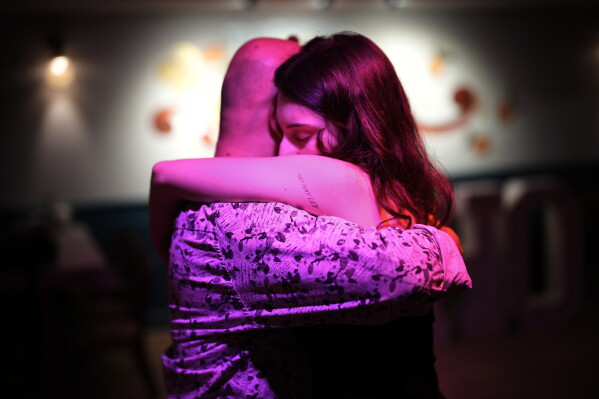 A tattoo in Spanish reading, "There is no law," decorates the arm of a woman dancing during a tango milonga session at Soho Tangoport in Istanbul, Turkey, Thursday, Jan. 29, 2026. (AP Photo/Francisco Seco)
