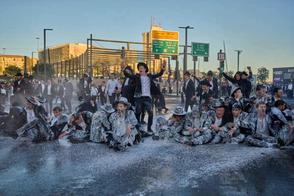 Israeli mounted police disperse Ultra-Orthodox Jews blocking a road during a protest against the army draft in Jerusalem, Monday, June 1, 2026. (AP Photo/Ohad Zwigenberg)