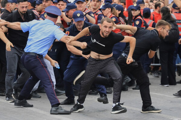 Protesters scuffle with police officers blocking a street during a demonstration in Tirana, Albania, Wednesday, June 3, 2026, opposing a luxury coastal development project linked to Jared Kushner and Ivanka Trump over concerns about environmental impacts and transparency.(AP Photo/Hameraldi Agolli)
