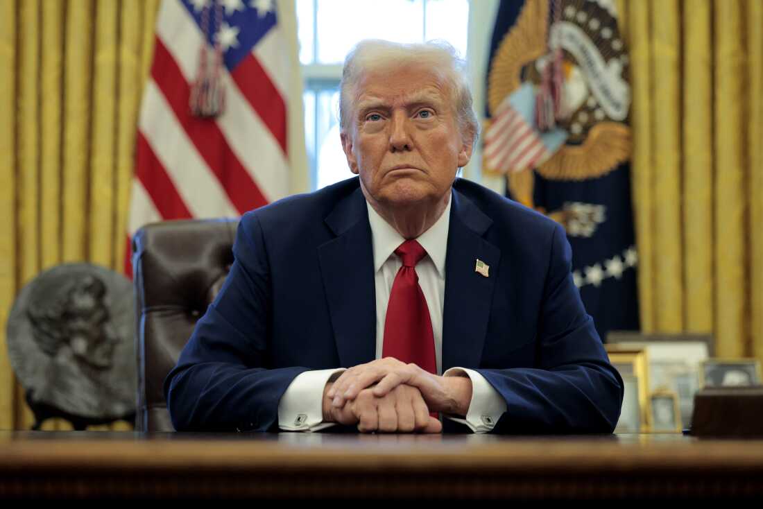 President Trump talks to reporters in the Oval Office at the White House on January 30, 2025.
