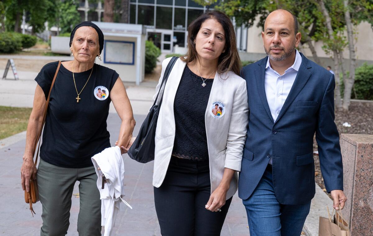 Karim Iskander, right, and wife Nancy Iskander, center,  (Brian van der Brug / Los Angeles Times)